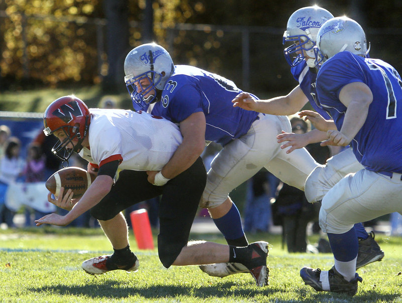 Wells quarterback Paul McDonough was the target of Mountain Valley's swarming defense throughout the Western Class B championship game Saturday at Rumford. Ryan Glover applies the hit – one of the five sacks that the Falcons leveled on McDonough.