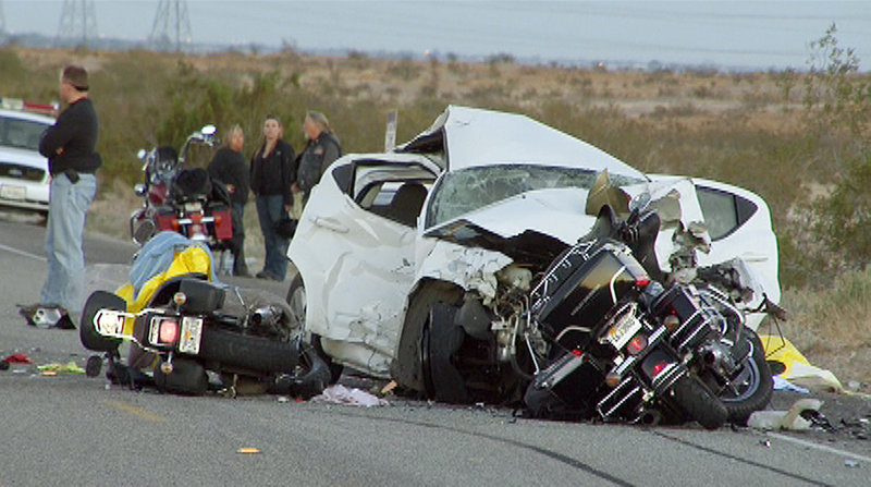 Rescuers and victims are seen at the site of a collision involving a car and several motorcycles on a remote desert highway near Ocotillo, Calif., in this photo taken from video made Saturday. The car’s driver was arrested on suspicion of driving under the influence.