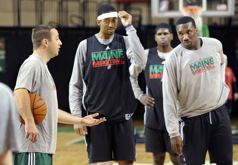 Coach Austin Ainge, left, talks to Magnum Rolle, Eugene Spates and Tiny Gallon during the Red Claws practice Tuesday at the Portland Expo. The Red Claws will be younger this season than the mostly veteran team that went 27-23 in the franchise s inaugural season.