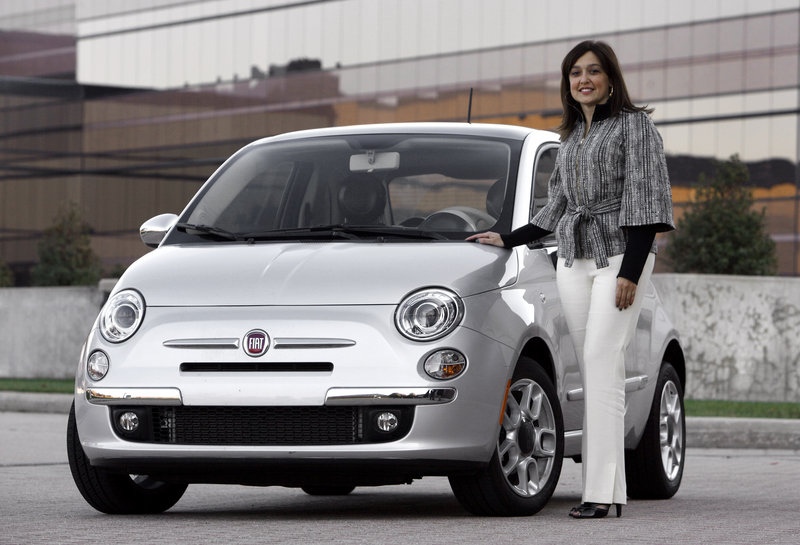 Laura J. Soave, head of the Fiat Brand for North America, stands next to a 2011 Fiat 500.