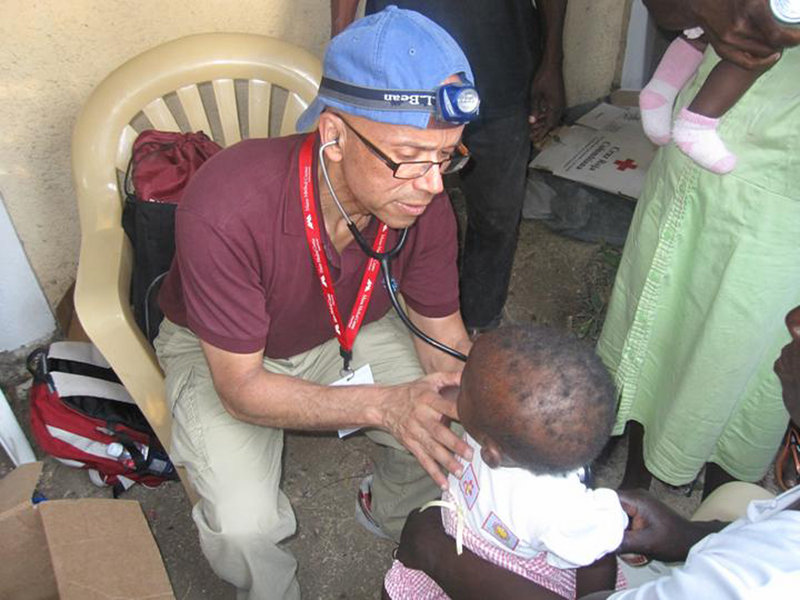 Dr. Hector Tarraza checks a young child while caring for earthquake victims in Port-au-Prince, Haiti, earlier this year. The Portland-based physician spends at least five weeks each year in poor communities from Haiti to Peru to Sierra Leone.