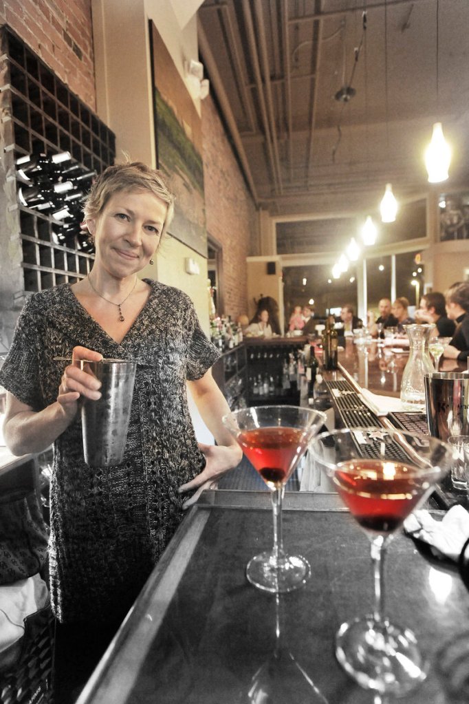 Co-owner and bartender Winnie Moody mixes martinis.