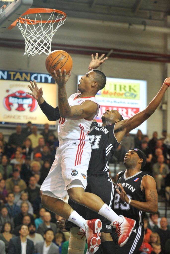 Lawrence Westbrook of the Maine Red Claws drives to the basket around Dominique Archie of the Austin Toros during Austin’s 103-97 victory Friday night in a D-League opener at the Portland Expo. The teams will meet again tonight at the Expo.