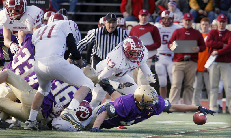 Andrew Bennett of Cheverus reaches to try and haul in a Bangor fumble in the first quarter of Cheverus 46-8 victory in the Class A championship game Saturday at Fitzpatrick Stadium.