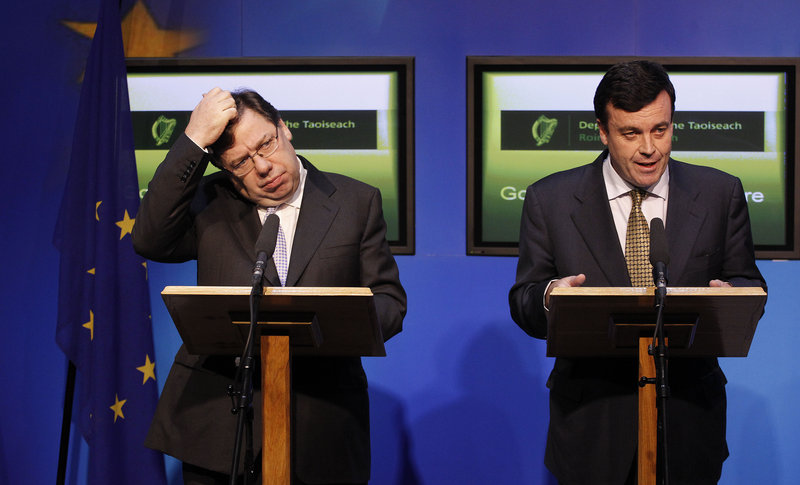 Irish Prime Minister Brian Cowen, left, and Finance Minister Brian Lenihan speak to the media in Dublin on Sunday. The debt-struck country Sunday formally appealed for a massive EU-IMF loan to stem the flight of capital from its banks.