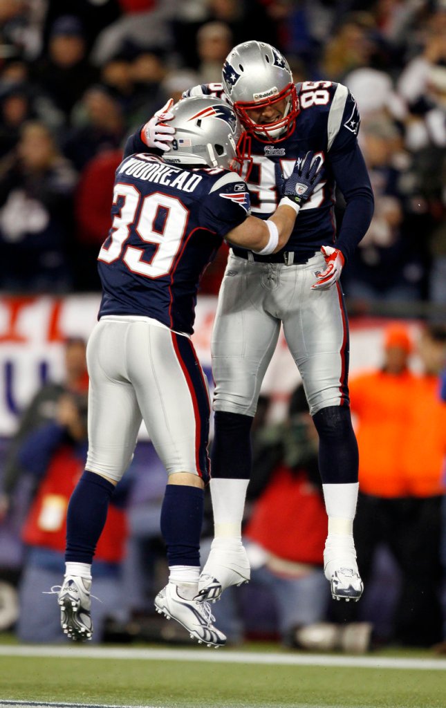 Aaron Hernandez, right, celebrates his second-quarter touchdown reception with Danny Woodhead on Sunday. It was Hernandez’s third touchdown catch of the year.