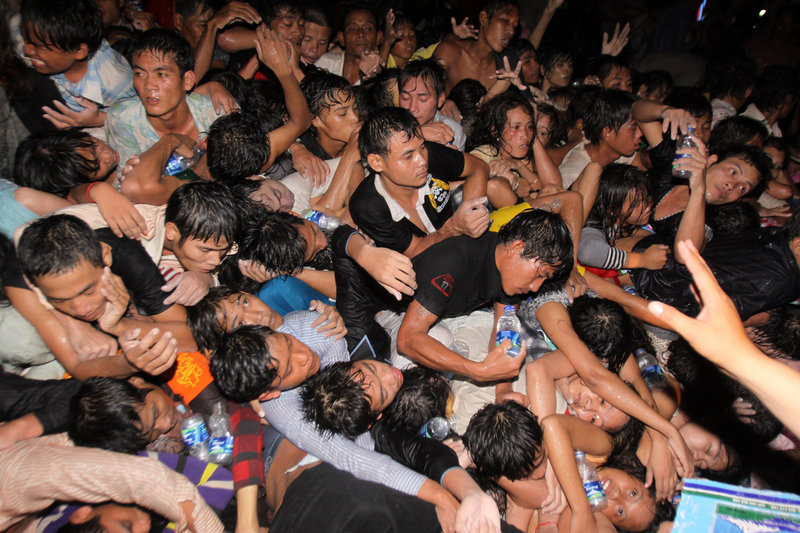 Cambodians attending a festival to celebrate the end of the rainy season are pushed onto a bridge Monday as they try to flee Diamond Island in Phnom Penh. Hundreds were injured, many severely, and the death toll was expected to rise.