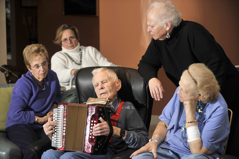 Ninety-year-old Jim Conley, center, plays the accordion and harmonica at Monday’s gathering of the Beacon Club, a support group for blind or visually impaired people from Greater Portland. The musician is surrounded by fellow club members and volunteers, from left, Ruth Cohen, Roberta Fishman, Jane Snerson and Gloria Lyons.