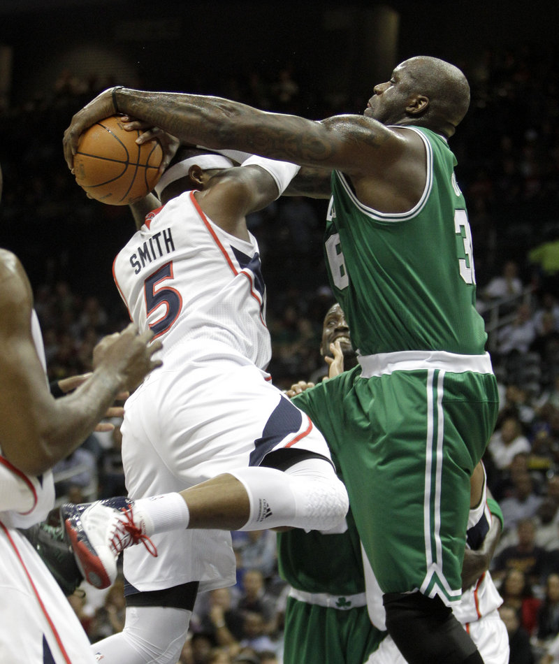 Atlanta’s Josh Smith, left, doesn’t have much luck going against Boston’s Shaquille O’Neal in the first quarter Monday night in Atlanta. O’Neal scored 13 as Boston blew out Atlanta.