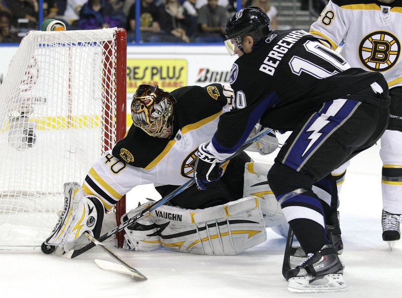 Sean Bergenheim of the Lightning tries to poke the puck away from Bruins goalie Tuukka Rask during Monday’s game at Tampa, Fla. Rask made 33 saves in a 3-1 loss.