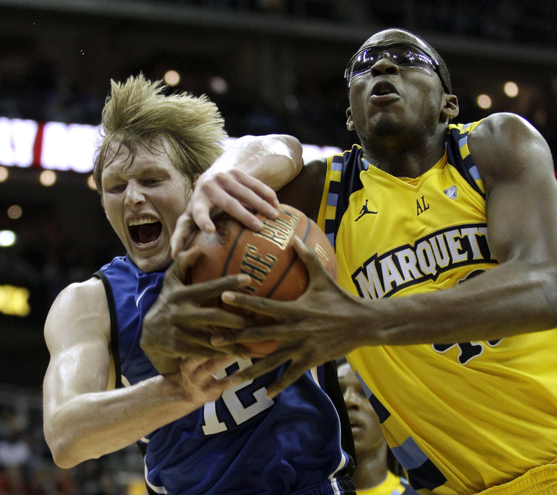 Duke’s Kyle Singler, left, and Marquette’s Chris Otule fight for a rebound during their CBE Classic semifinal Monday night in Kansas City, Mo. Top-ranked Duke won, 82-77.