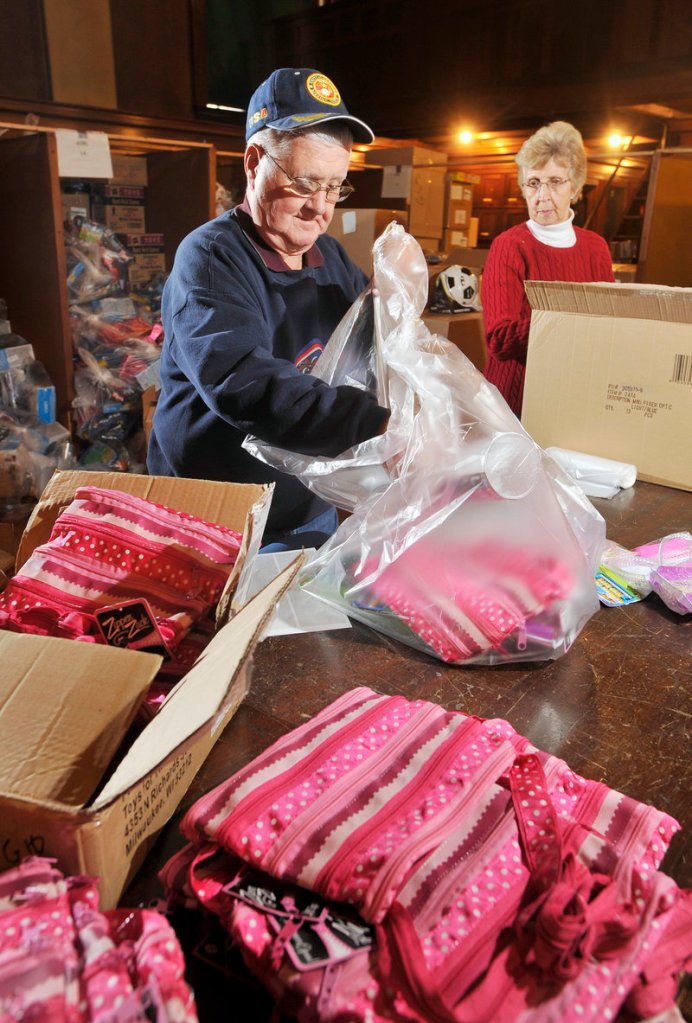 Walter and Nina Braley, of Standish, long-time volunteers for the Bruce Roberts Toy Fund, prepare gift bags targeted for a young girls. The fund, which serves thousands of needy children in southern and coastal Maine is in its 62nd year.