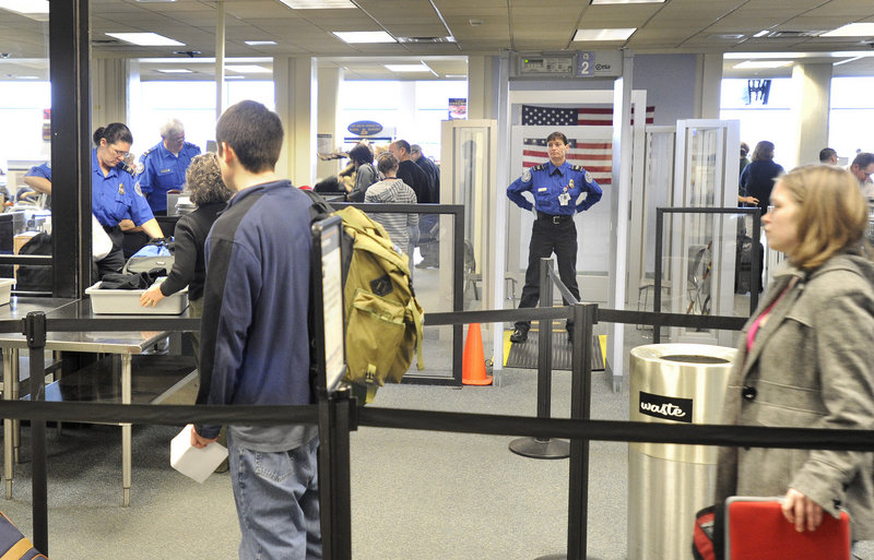 Travelers await screening by Transportation Security Administration employees Tuesday in Portland. The TSA plans to expand the use of X-ray body scanners at airports next year, but a spokeswoman said she couldn’t say whether Portland will get one.