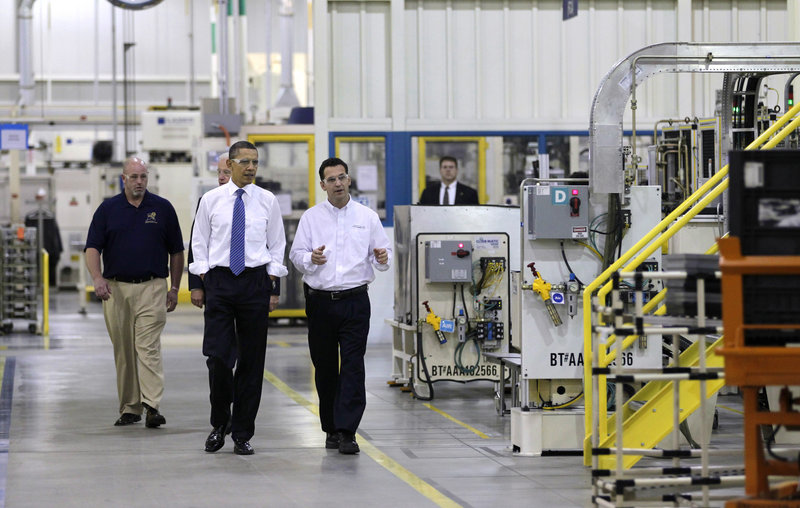 President Obama, with Vice President Biden behind him, tour Chrysler’s Indiana Transmission Plant II in Kokomo on Tuesday. At right is plant manager Jeremy Keating, at left is Richie Boruff, president of United Auto Workers Local 685.