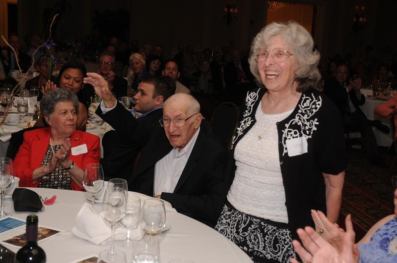 Rose Novick, standing, and Jack Novick are applauded last June during a Jewish Community Alliance fundraising dinner.