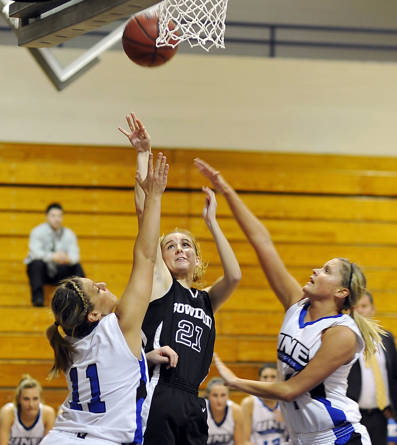 Ellery Gould of Bowdoin finds space to shoot between Liz LeBlanc, left, and Kelley Paradis of UNE. To go with a strong defense, the Polar Bears shot 50 percent, and were 10 of 18 on 3-pointers.