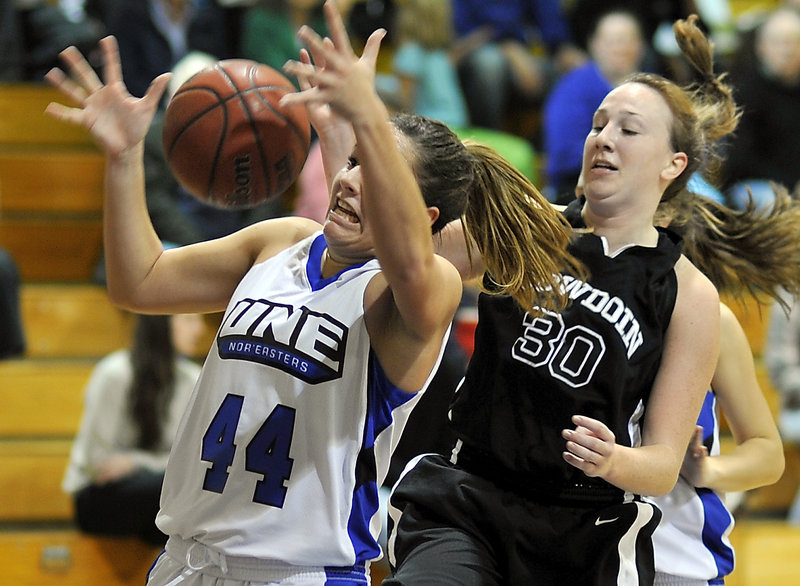 Beth Suggs of the University of New England, left, attempts to control a rebound Tuesday night after gaining inside position on Colleen Sweeney of Bowdoin during Bowdoin’s 82-55 victory. It was UNE’s first setback after four wins.