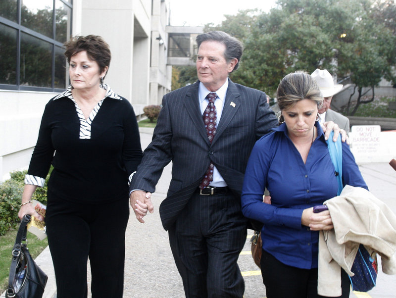 Former House Majority Leader Tom Delay, his wife, Christine, left, and daughter Danielle leave the Travis County Courthouse in Austin, Texas, on Wednesday. He remains free on bond and his sentencing is set to begin Dec. 20.