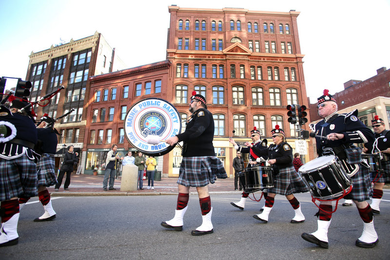 Members of the Maine Public Safety Pipe and Drum Corps play during the Veterans Day Parade in Portland. “When you start feeling it, it really flows,” says teen bagpiper Colin Arnold.