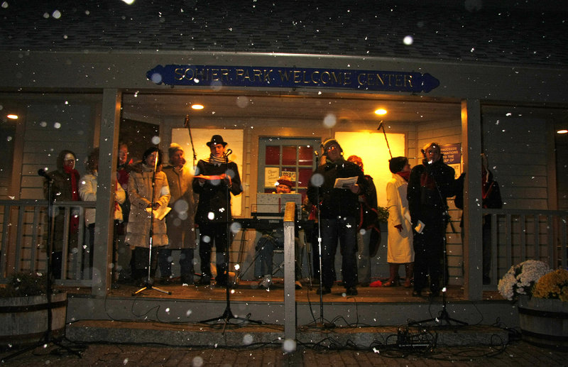 The Coastal Capers perform holiday melodies as snow falls Saturday afternoon.