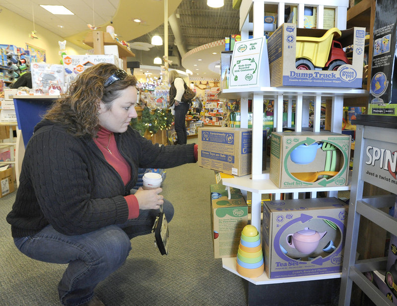 Annette Woodbury of Gray looks at Green Toys, which are made of recycled material, on Monday at Rainbow Toys in Falmouth.