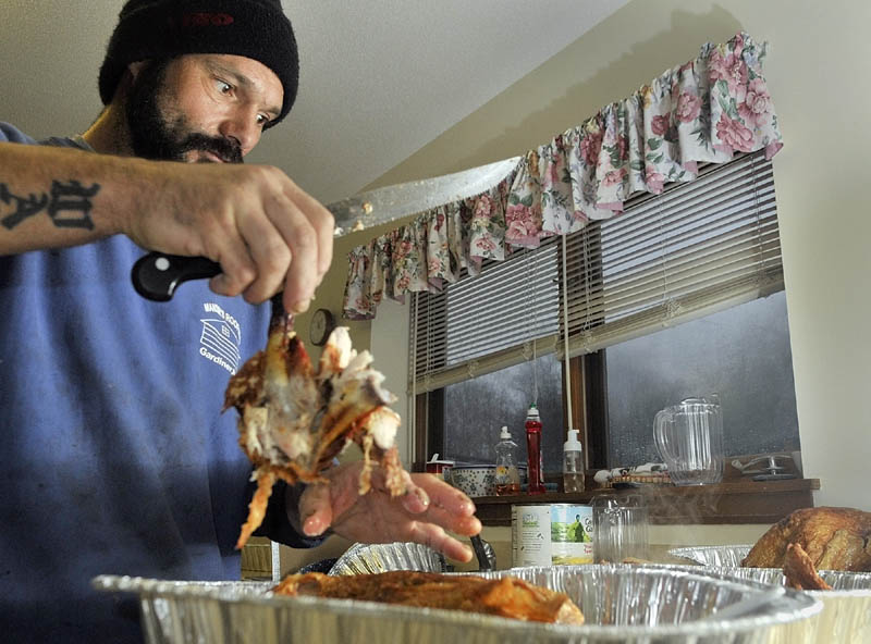 Gary Wallace carves one of four turkeys cooked on Wednesday at Highland Avenue Terrace in Gardiner.