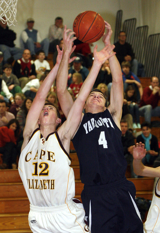Luke Pierce of Yarmouth, right, attempts to haul in a rebound Tuesday night against Henry Babcock of Cape Elizabeth in the second half. Yarmouth came away with an 84-61 victory on the road.