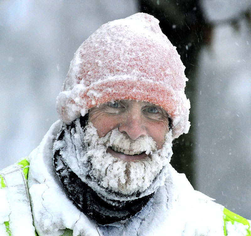 Portlander Chester Bishop smiles as he snowblows a fire hydrant in front of his Pitt St. home as he and all Mainers start to dig out from the largest snowstorm of this season so far. Portland area is expecting 12 to 18 inches.