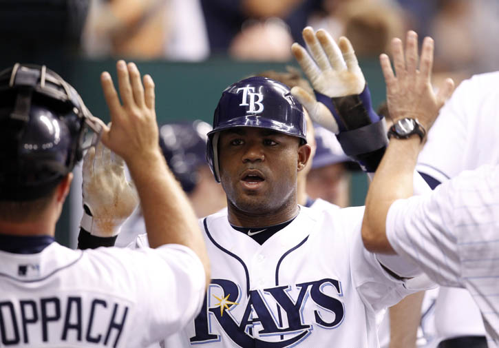 A July 27, 2010, photo of Carl Crawford being congratulated after scoring in the sixth inning of the Rays' 3-2 victory over the Detroit Tigers.