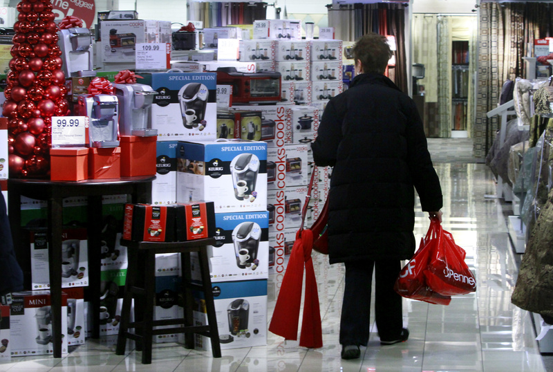 In this Dec. 16, 2010 file photo, a shopper eyes cooking ware gift sets at the J.C. Penney store at Herald Square, New York. A new survey shows consumer confidence dipped in December, even after other reports suggest people increased their holiday spending at the biggest rate in four years.