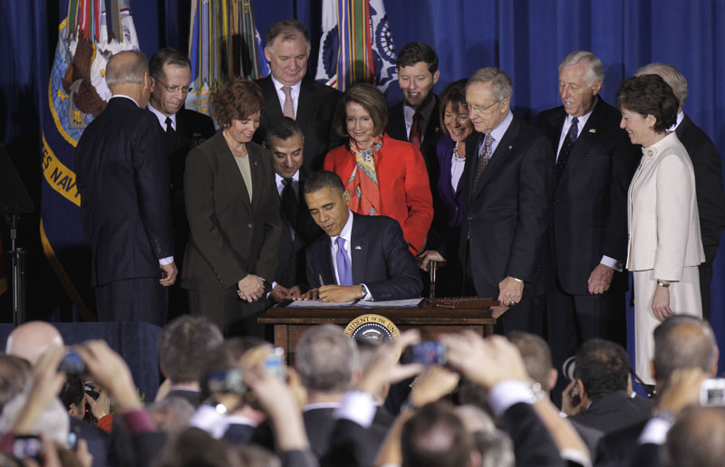 President Barack Obama signs the Don't Ask, Don't Tell Repeal Act of 2010 this morning at the Interior Department in Washington. Maine Sen. Susan Collins looks on at right. Collins and Sen. Joseph Lieberman of Connecticut were sponsors of the bill in the Senate.