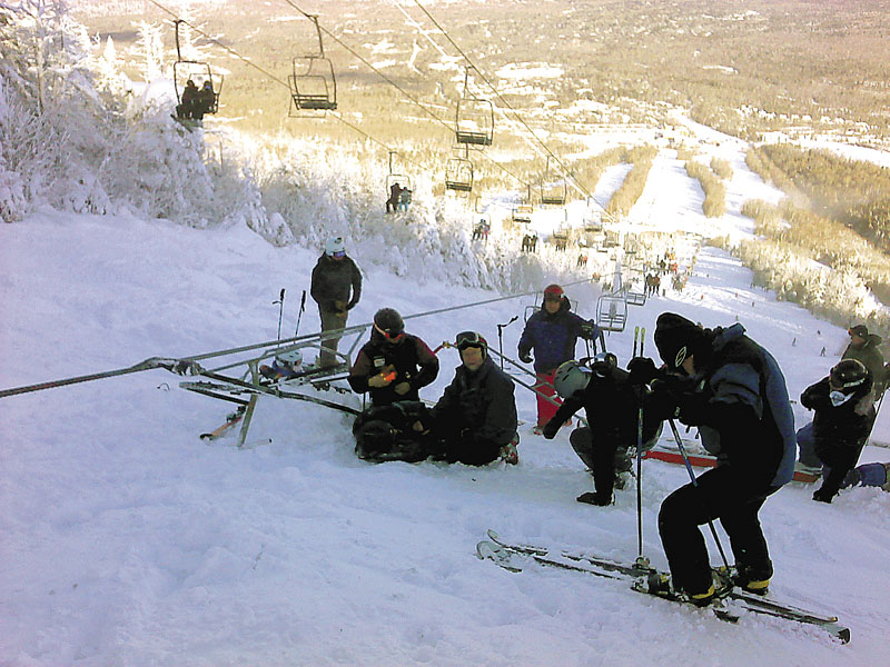 Skiers await rescue after the Spillway East chairlift derailed, sending riders 30 feet down to the snow below.