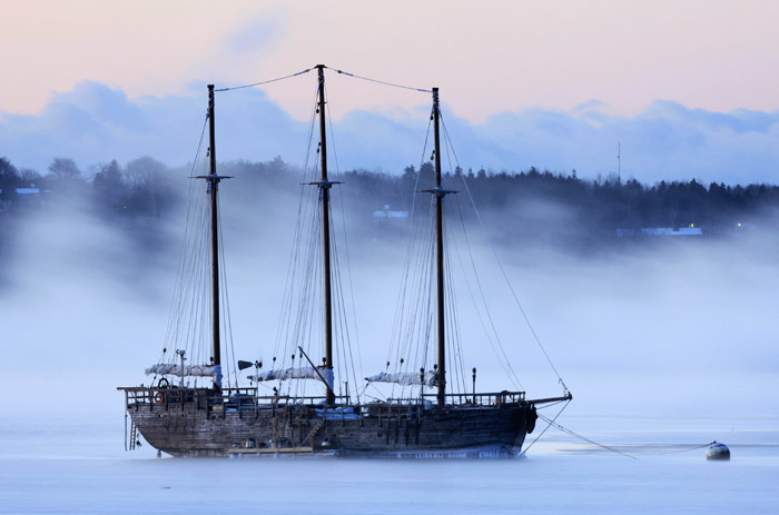 Sea smoke drifts by the Raw Faith in Rockland, Maine, In this Jan. 16, 2009, photo.