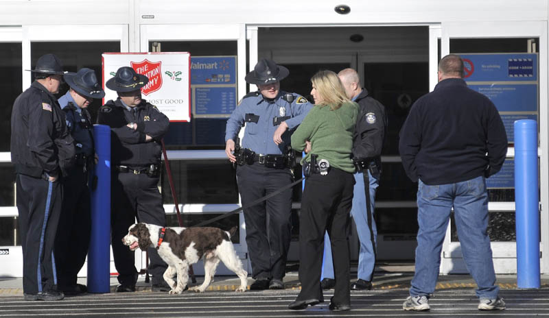 Maine State troopers and police officers stand at the entrance to the the Walmart in Skowhegan with a bomb-sniffing dog after a bomb threat was investigated Thursday afternoon.