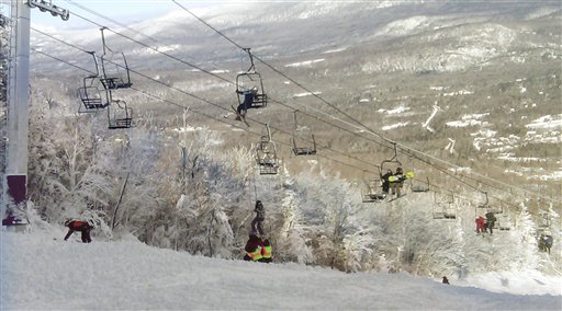 A skier is helped down from a lift chair, center, after the chairlift derailed at the Sugarloaf resort on Tuesday.