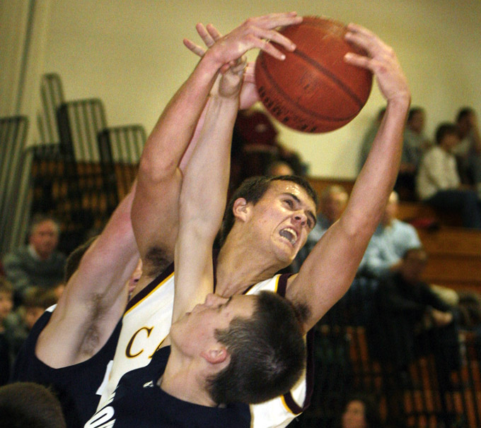 Kyle Danielson of Cape Elizabeth pulls down a rebound over Sam Torres of Yarmouth during the second half of Yarmouth s 84-61 victory in a Western Maine Conference schoolboy basketball game Tuesday night.