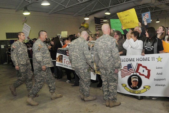 Members of the Maine Army National Guard's Bravo Company 172nd Mountain Infantry are greeted by family and friends as they enter the Air Force Reserve Center in Bangor today.