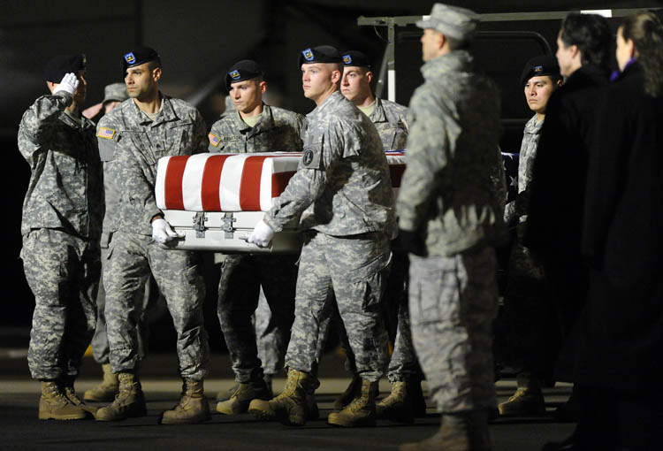 An Army carry team carries a transfer case containing the remains of Pvt. Buddy W. McLain at Dover Air Force Base, Del., on Wednesday.