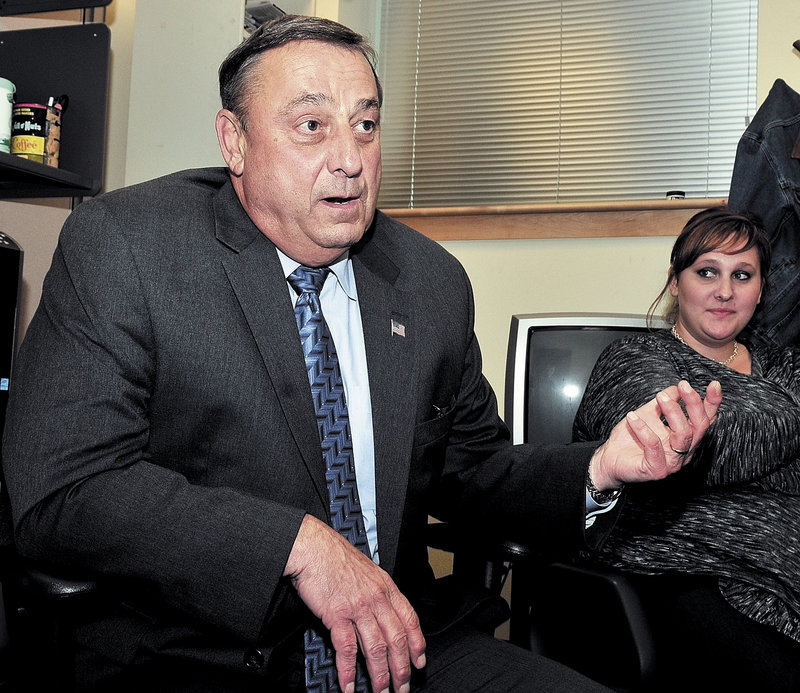 Paul LePage answers questions about his candidacy during a session with reporters in September in Augusta. At right is his daughter Lauren, 22, who has been hired as an assistant by the governor-elect's administration. She will be paid $41,000 a year.