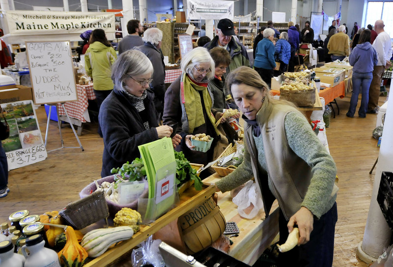 Jan Goranson of Goranson Farm in Dresden waits on customers last weekend at the bustling Brunswick Winter Market at Fort Andross.