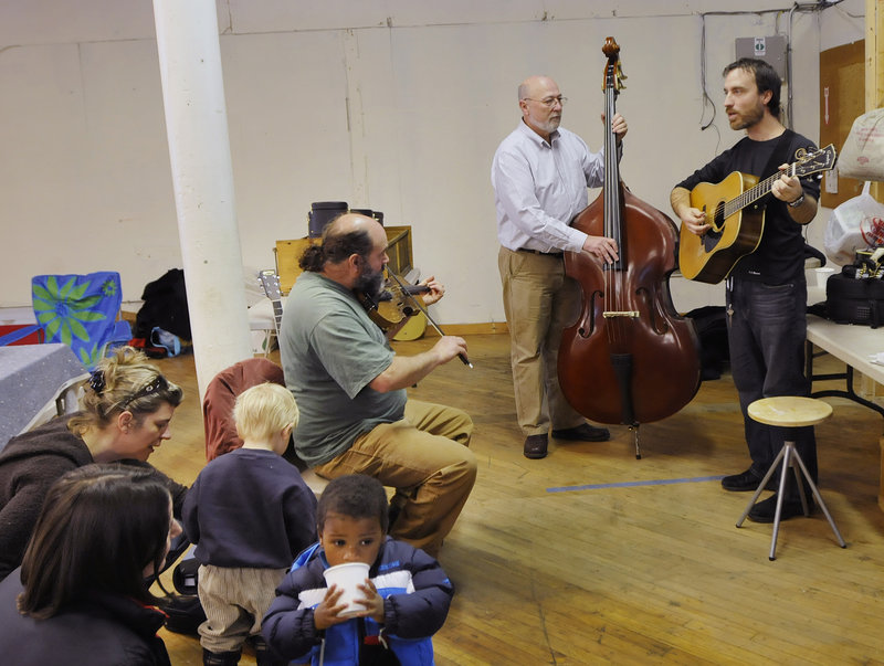 Musicians Jeff Raymond of Pownal, on the fiddle; Dick Durgin of Brunswick, on the upright bass; and Craig Hensley of Bowdoinham, on the guitar, entertain during the Brunswick Winter Market last Saturday.
