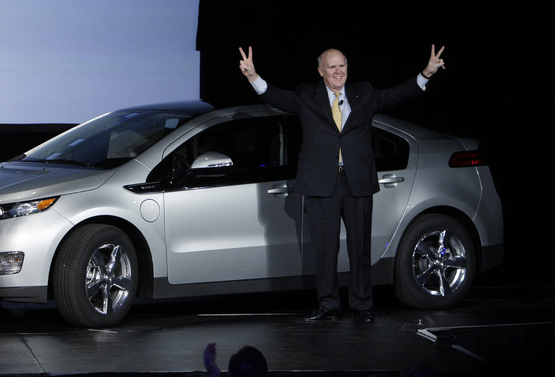 General Motors CEO Dan Akerson, who makes $9 million in annual compensation, celebrates one of the first Chevrolet Volts last month at the plant in Hamtramck, Mich.