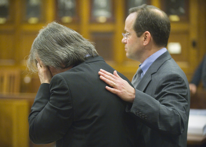 William Hanaman reacts Tuesday to opening statements as his lawyer, Robert Levine, tries to comfort him. Levine said Hanaman acted in self-defense when he killed his girlfriend.