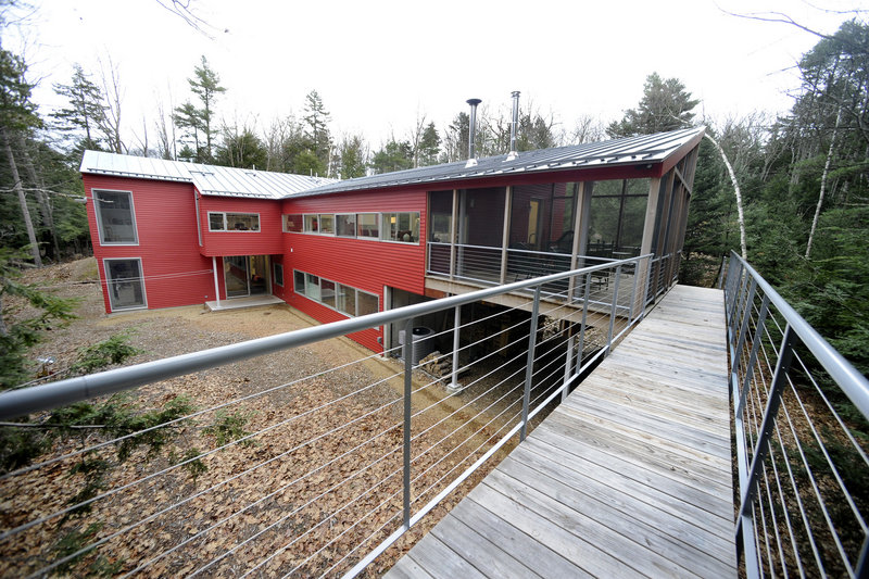 An exterior shot of the Weir home, with its elevated walkway off a large screened-in porch.