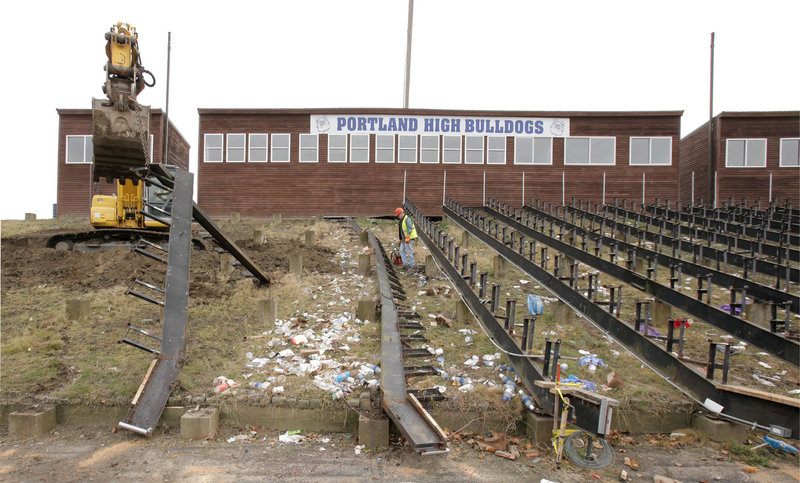 Workers from the city’s public services department remove bleachers Tuesday at Fitzpatrick Stadium. Heavy equipment is used to take out large sections of seating.
