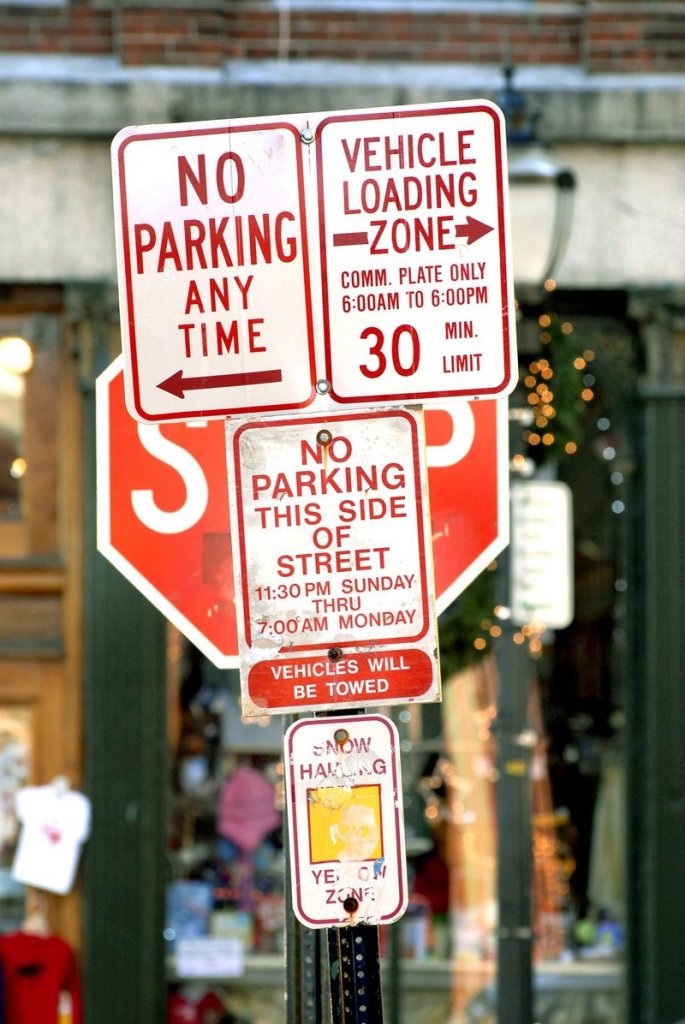 Signs in Portland show that parking can indeed be a problematic issue downtown.