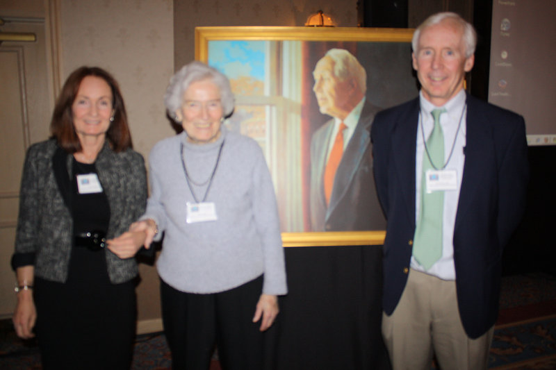 Standing next to a portrait of Dr. Daniel Hanley are, from left, his daughter Sheila Hanley; his widow, Maria Hanley; and his son Dr. Sean Hanley.