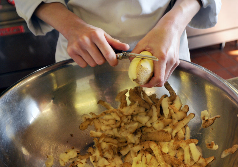 Samantha St. Germain of Oakland peels potatoes as she prepares lunch as part of the advanced cooking specialties program at Southern Maine Community College.