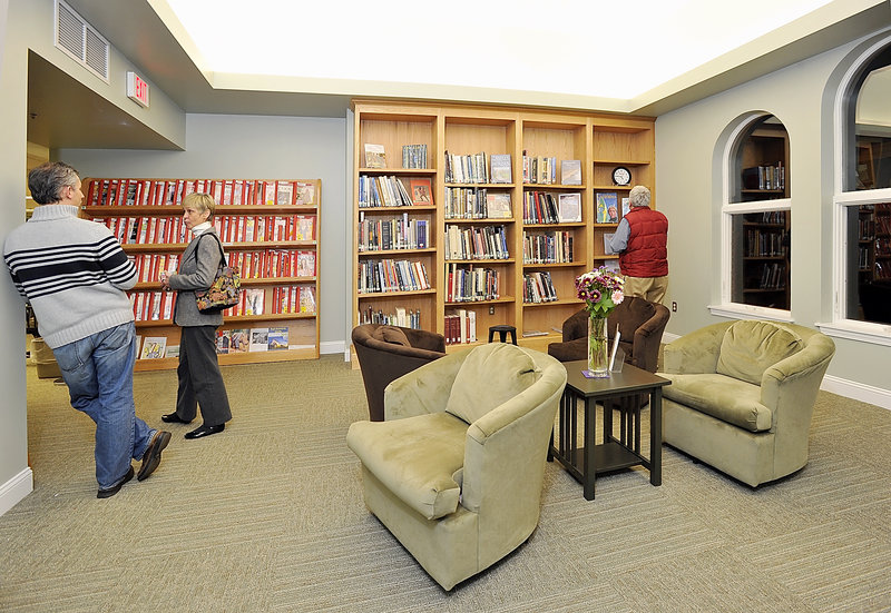 Visitors explore the new Henrietta Carroll Room at Thursday’s grand opening of the McArthur Library renovations. Carroll, a past library trustee, “would have loved this,” said her granddaughter Abigail Carroll.