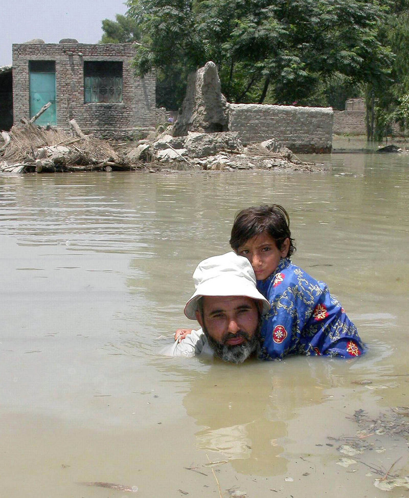 Disasters, like this flooding in Pakistan in 2005, can’t be directly linked to climate change, but temperatures around the globe are climbing, says a U.N. weather panel.
